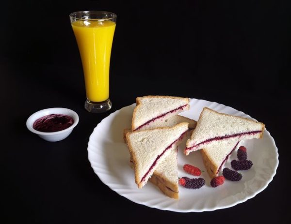 Scrumptious mulberry jam sandwiches with a refreshing glass of fresh country mango juice!